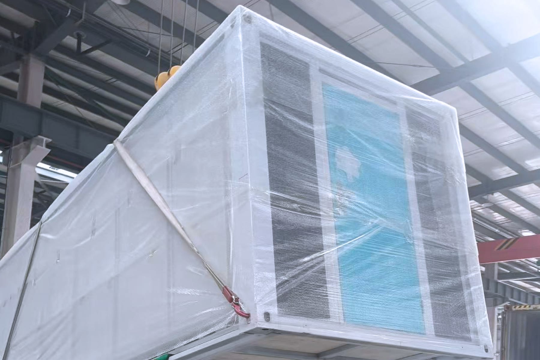 Folded expandable house protected with wrapping before container loading